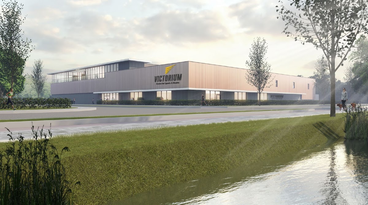 Victorium padel club, modern grijze gebouw met groene surroundings en water.